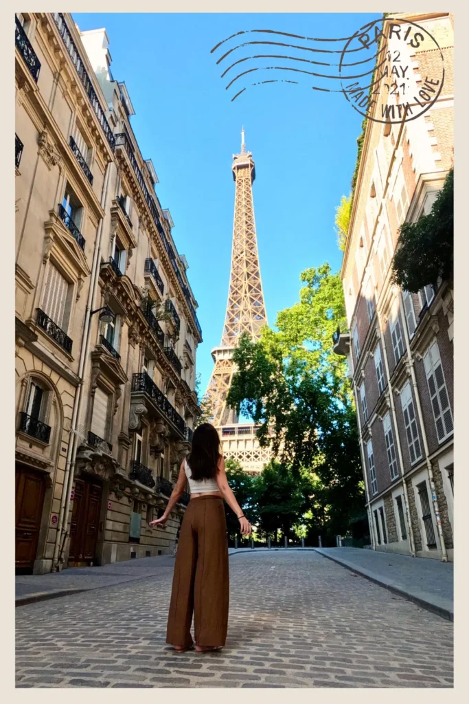 Girl on famous Rue de l'universite looking at the Eiffel Tower on a sunny day in Paris.