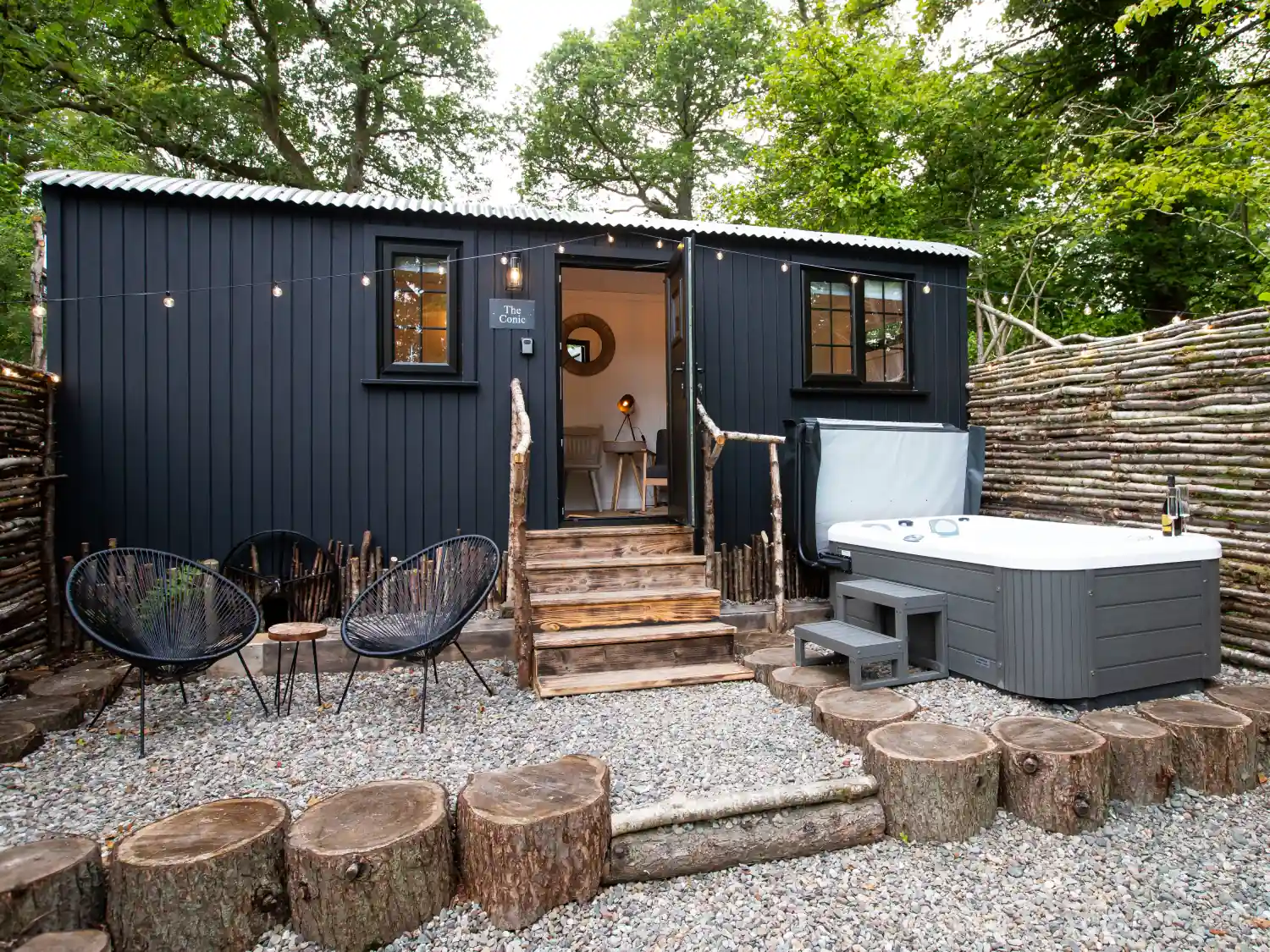 The Mar Huts accommodation featuring the beautiful hut with fairy lights and a hot tub outside.