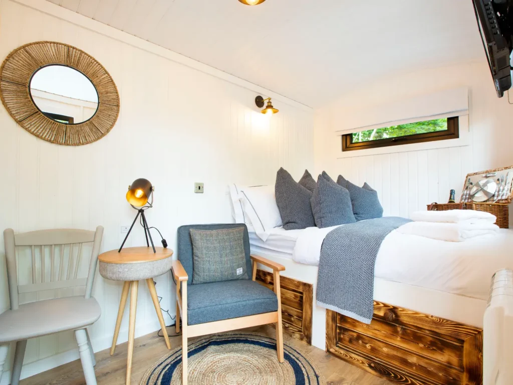 Interior of the Mar Huts in Loch Lomond showing cosy bed and seating area.