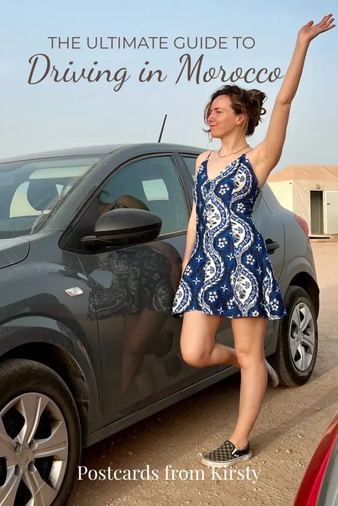 Pinterest Pin showing woman standing in front of the car with arm up in the air with text over the top reading "Best EuropeanThe Ultimate Guide to Driving in Morocco" and "Postcards from Kirsty"