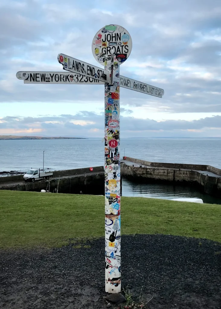 The famous John O'Groats Signpost on a cloudy day.