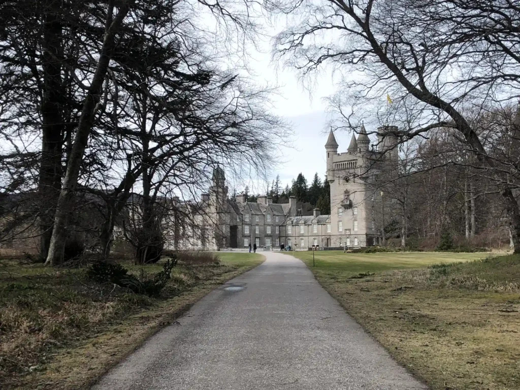 Road leading up to Balmoral Castle with trees either side.