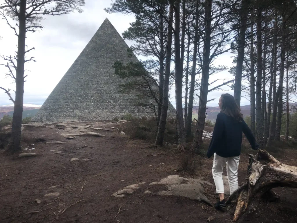 Girl with back to the camera looking at Prince Albert's Cairn in Scotland.