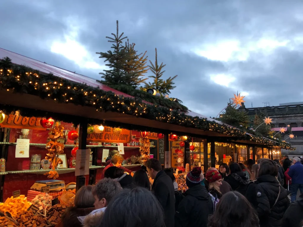 Lots of people queuing up at the Christmas market stalls in Prince Street Gardens in Edinburgh.