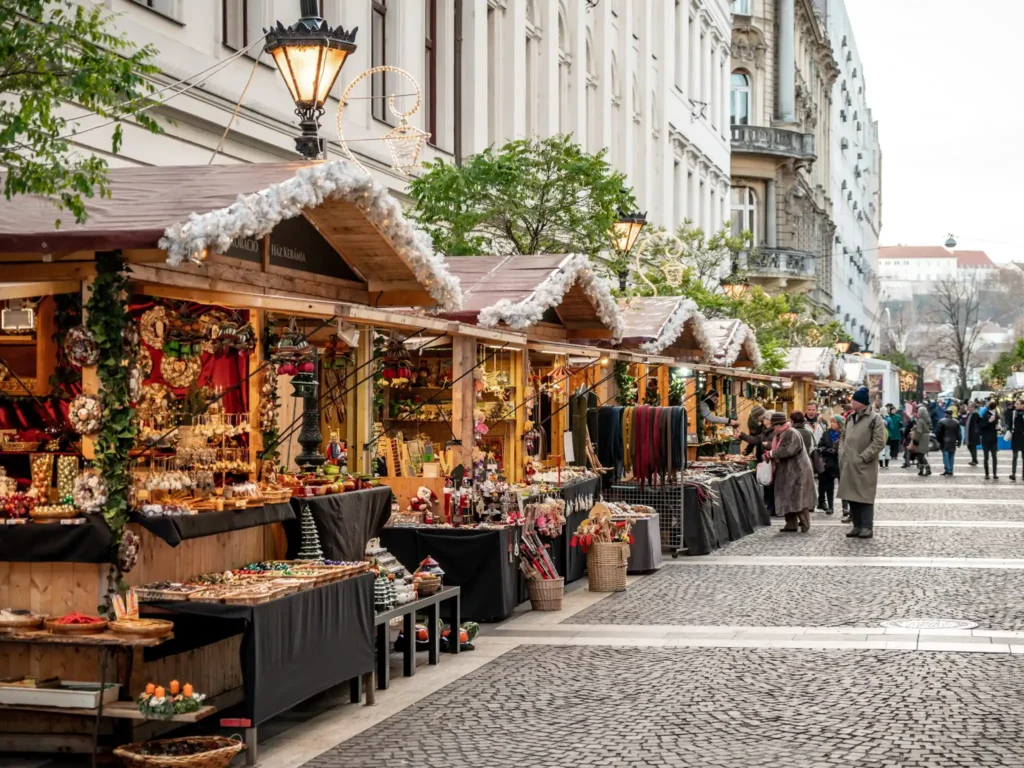 Line of Christmas market stalls in front of St Stephen Basilica in Budapest.