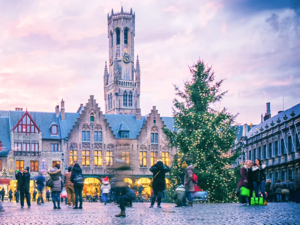 Christmas Tree in De Burg with Bell Tower in the background in Bruges.