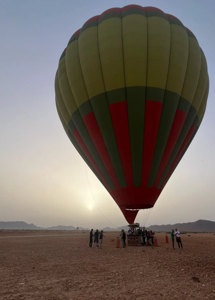 Hot air balloon being set up in Marrakech at sunrise.