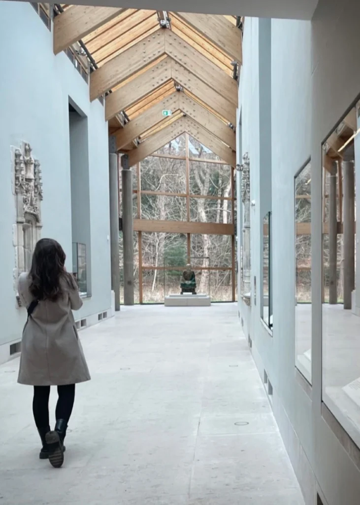 Girl with back to the camera looking down a hallway in the Burrell Collection in Glasgow.