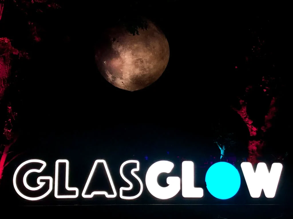 Glasglow sign with illuminated moon on top at Botanic Gardens in Glasgow.