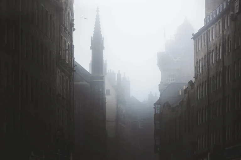 Haunting, spooky and moody atmospheric old town edinburgh along the medieval royal mile in misty fog.