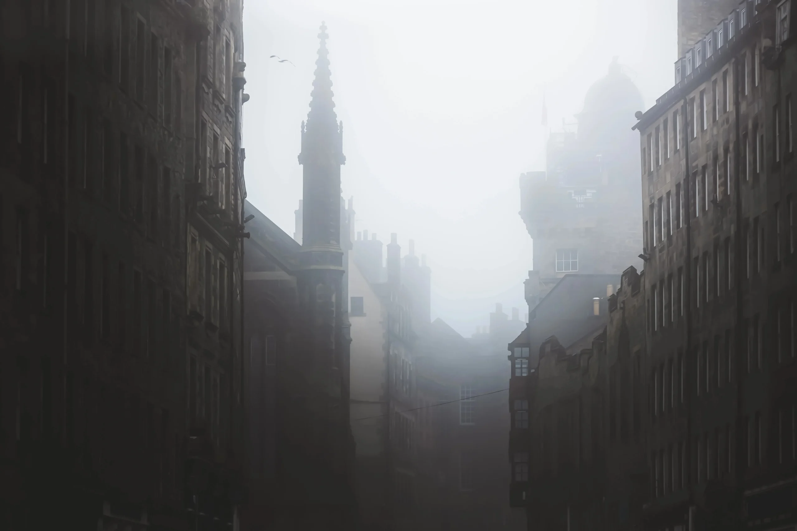 Haunting, spooky and moody atmospheric old town edinburgh along the medieval royal mile in misty fog.