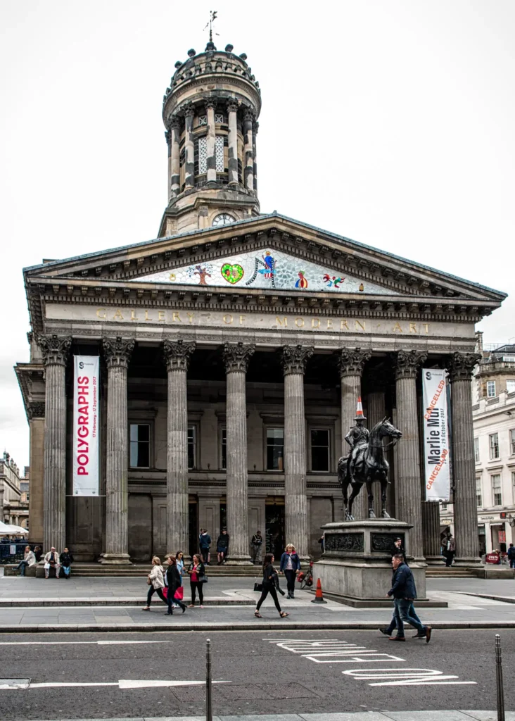 Exterior of the Gallery of Modern Art building in Glasgow on a cloudy day.