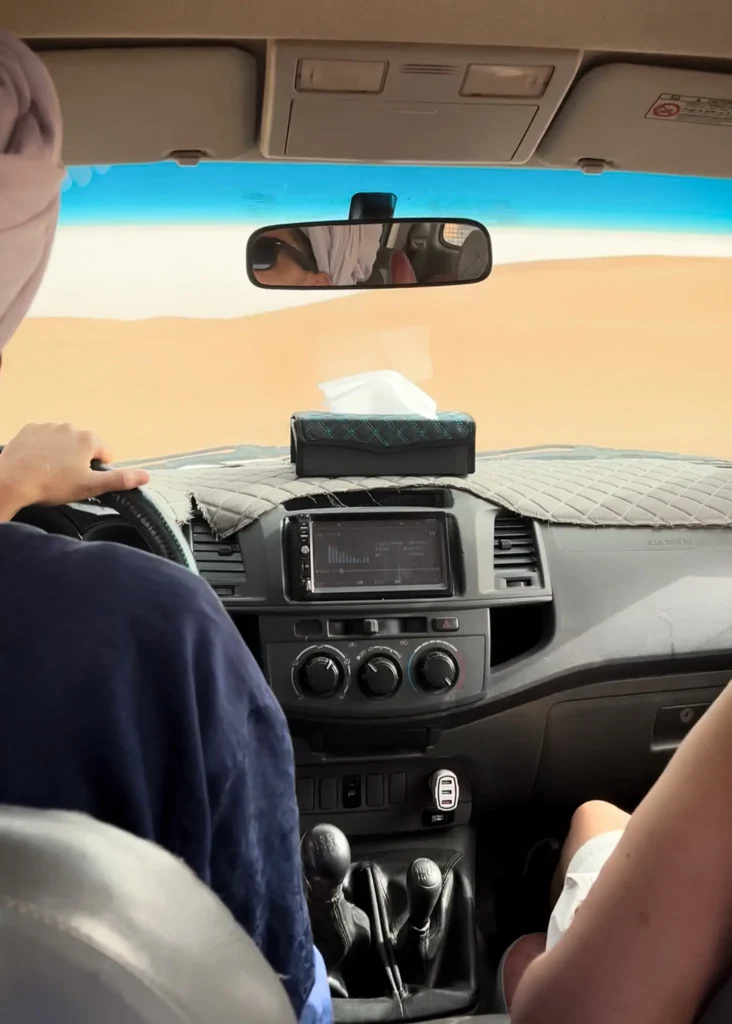 Photo from insider of a Jeep going over the dunes in the Sahara Desert.