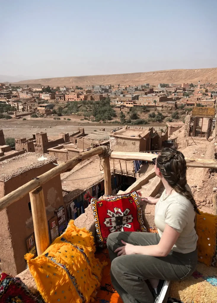 Girl sitting in a cafe in Ait Ben Haddou overlooking the village on the other side.