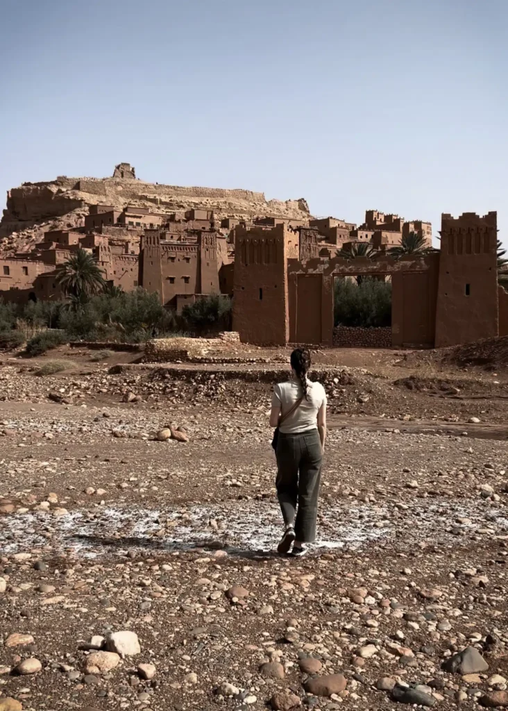 Girl walking towards the entrance gate in front of Ait Ben Haddou.