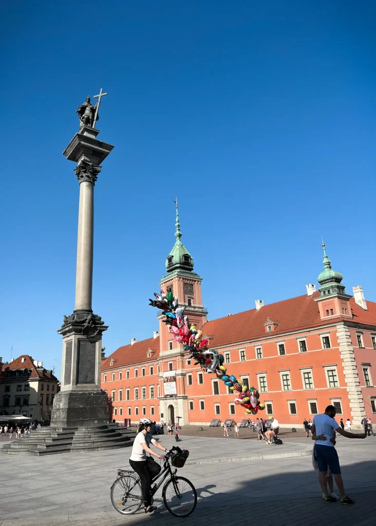 Cyclist in front of the Royal Castle in Warsaw in Poland.