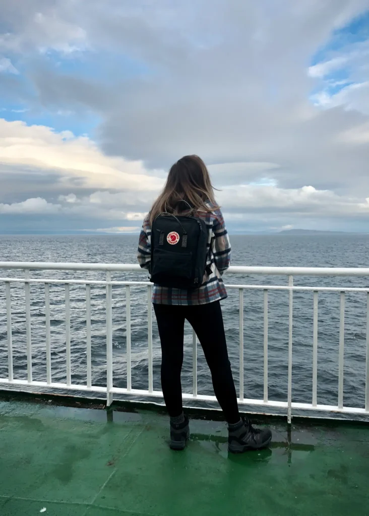 Girl wearing a Fjällräven Kånken Classic Backpack on a ferry to Arran in Scotland.
