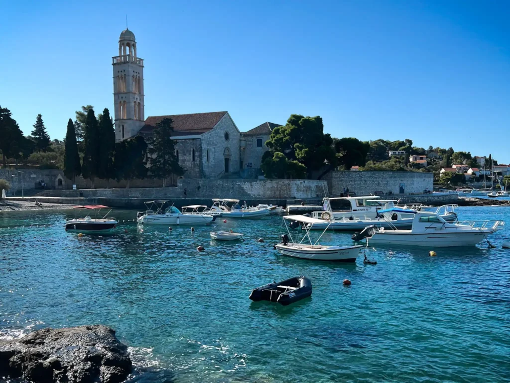Overlooking the water with boats and the Franciscan Monastery in Hvar, Croatia.