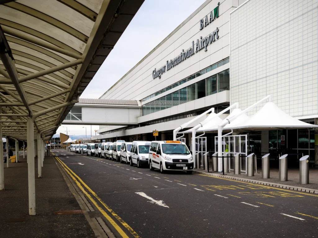 Taxis waiting outside the main terminal building of Glasgow International Airport.