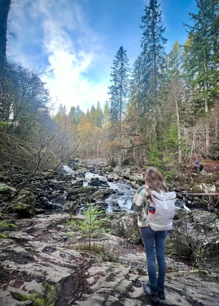 Girl standing looking out to the view at the Hermitage in Scotland.