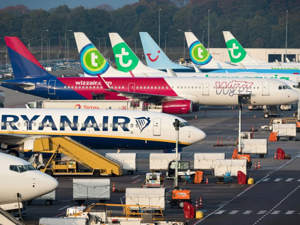 Various low-budget airline aircraft parked at the terminal of Eindhoven-Airport. 