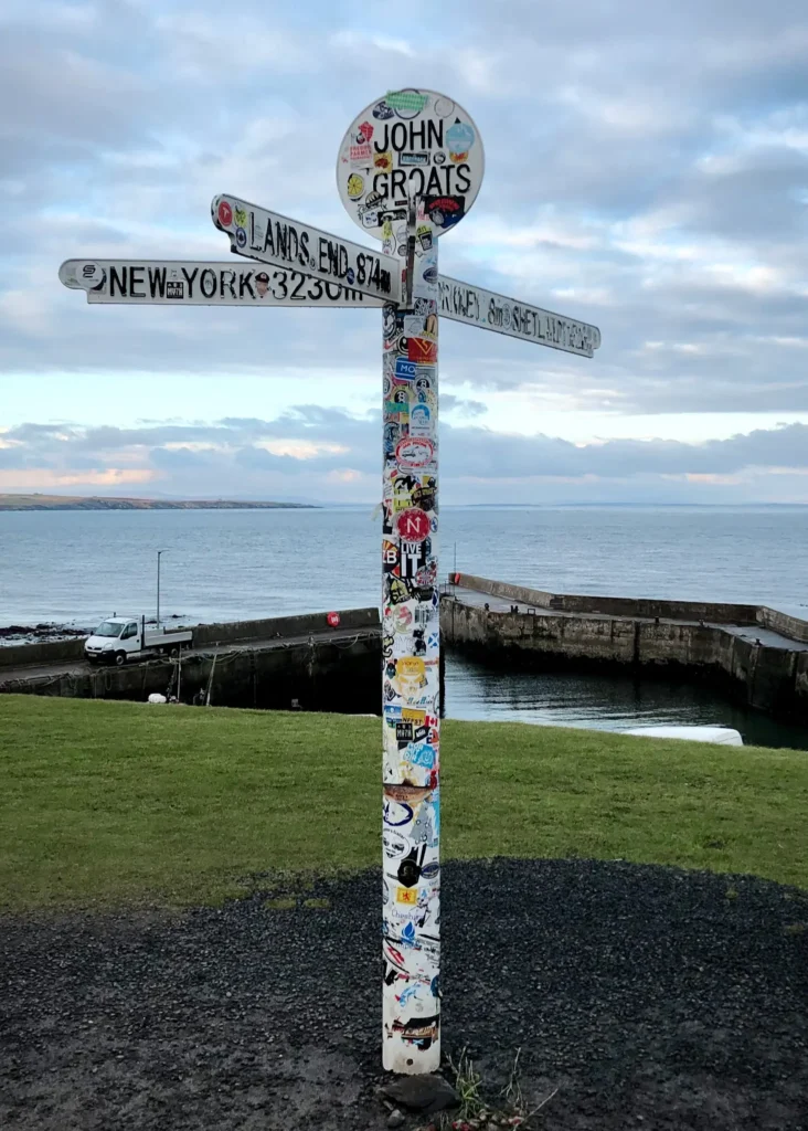 John o'Groats signpost on a cloudy day.