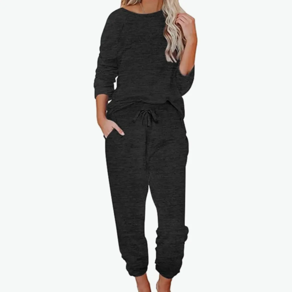 Woman with blonde hair wearing a black comfy jumper and trousers