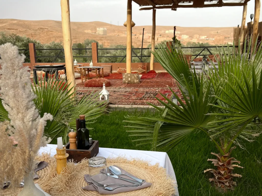 Table set up for dinner with terrace and landscape in the background at Riad Sahara Stars Dades.