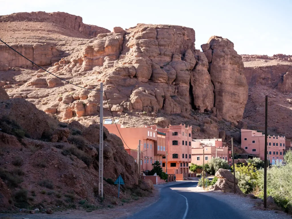 Road going through the Dades Valley in Morocco leading up to houses.