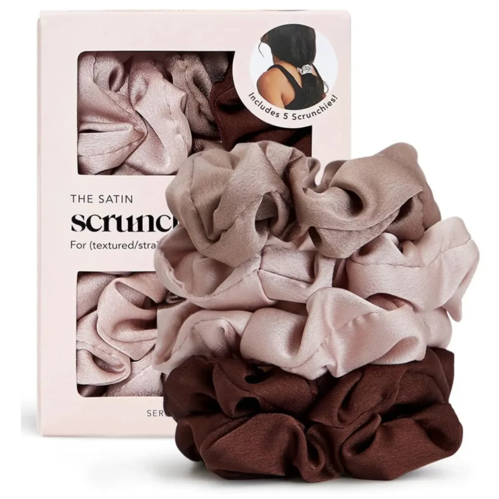 Satin hair scrunchies with packaging in the background.