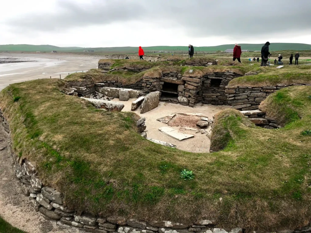 Skara Brae prehistoric village in Orkney on a cloudy day.