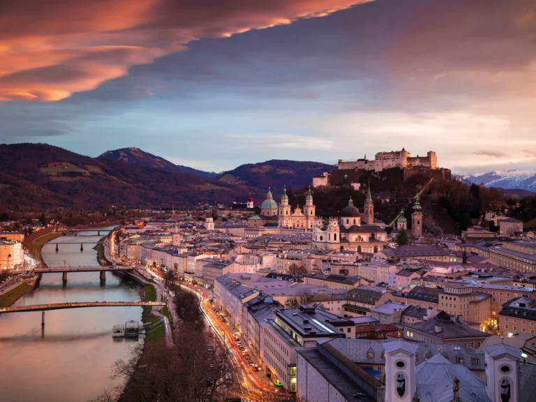 cityscape image of the salzburg, austria with salzburg cathedral during beautiful winter sunset.