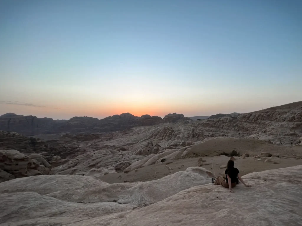 Girl watching the sunset at a viewpoint near Petra in Jordan.