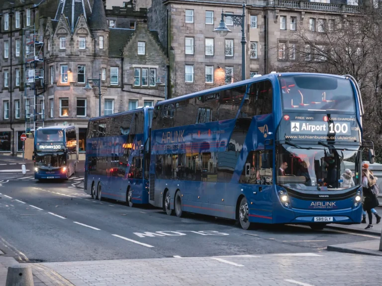 Airport line 100 buses on waverley bridge in historic part of edinburgh.