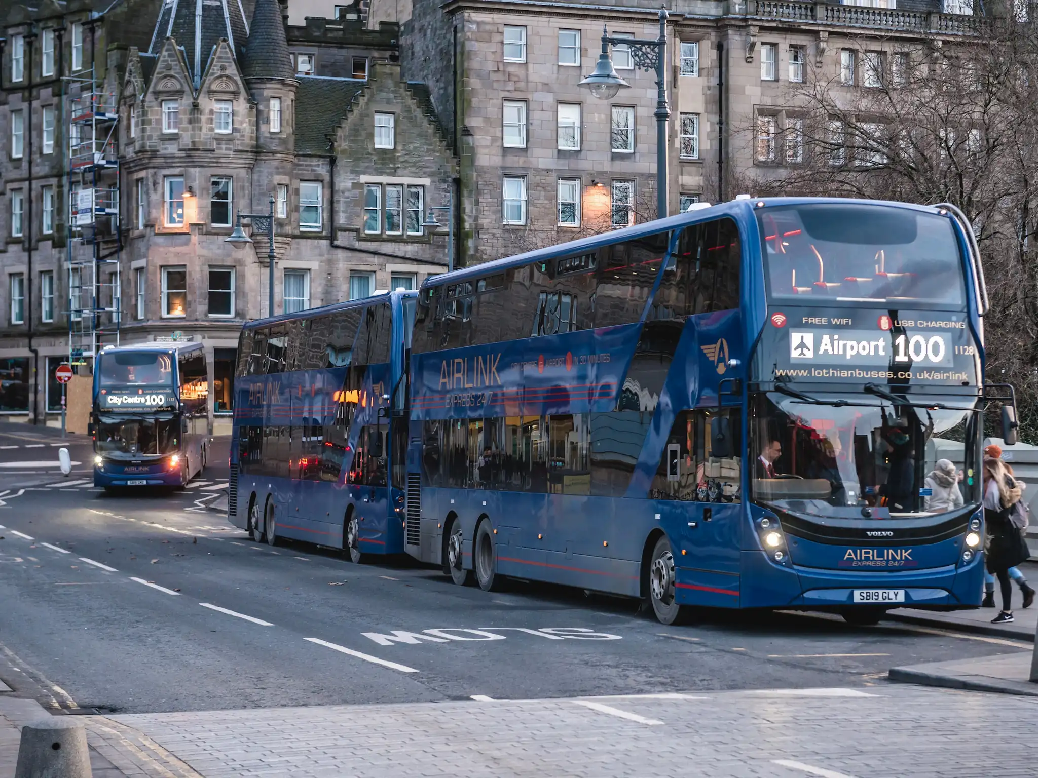 Airport line 100 buses on waverley bridge in historic part of edinburgh.