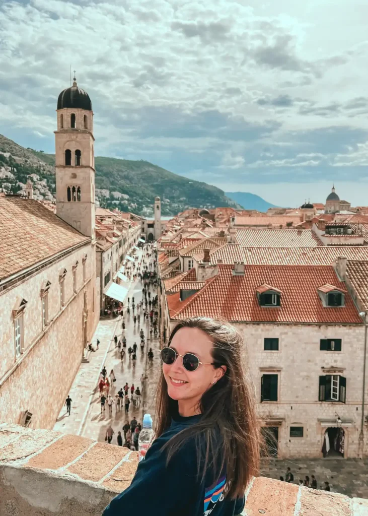 Girl smiling at the camera overlooking the main street in Dubrovnik.
