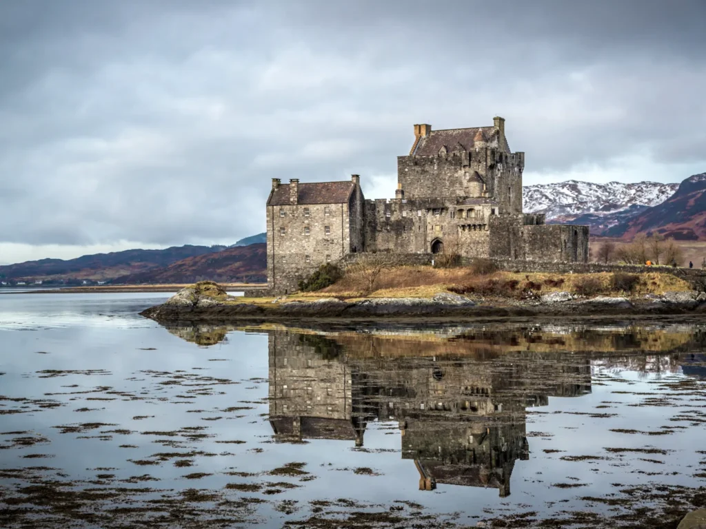 Eilean Donan Castle with reflection on the water on a moody day in Scotland.