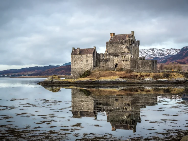 Eilean Donan Castle with reflection on the water on a moody day in Scotland.