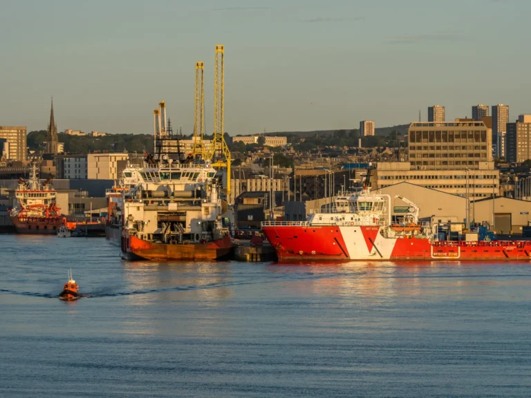 Aberdeen harbour basin, ships, piers and city centre.