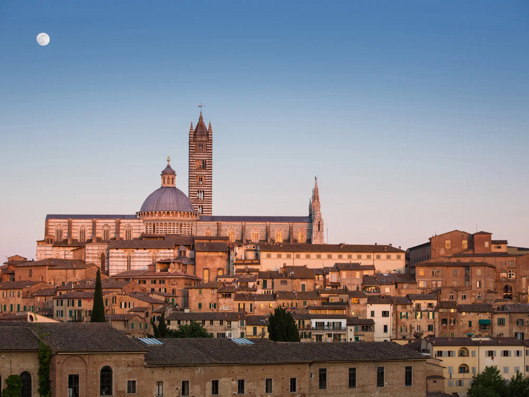 Siena cityscape at sunset with cathedral