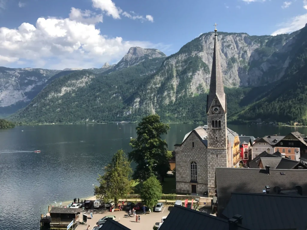 Photo of the Evangelical Church in Hallstatt and Hallstatter See and mountains in the background.