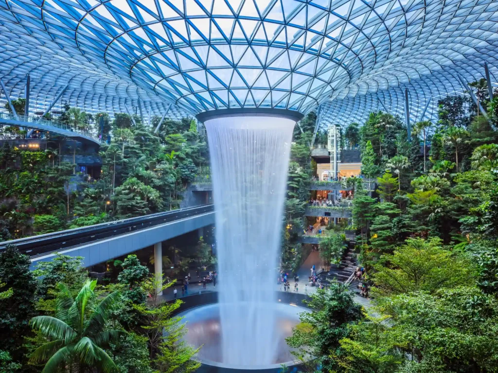 The world's tallest indoor waterfall, named the Rain Vortex, which is surrounded by a terraced forest setting at Jewel Changi Airport, Singapore.