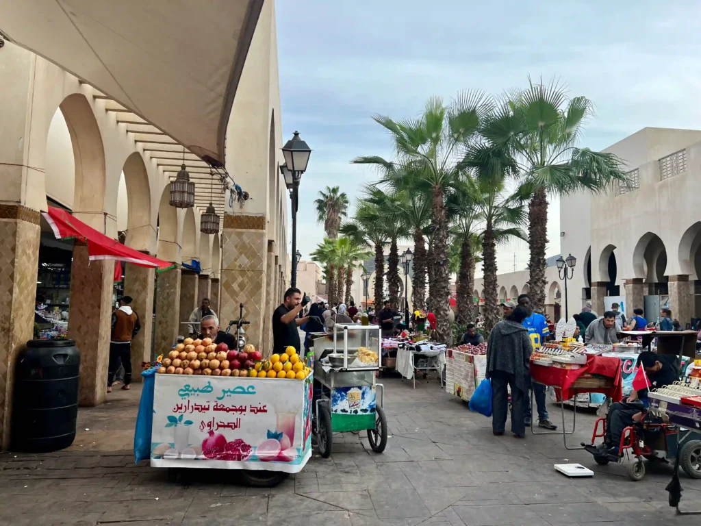 Vendors selling fresh fruit juice and other stalls at Agadir Market.