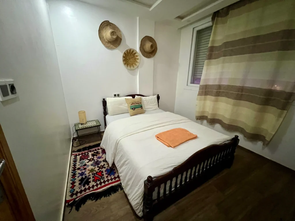 Private room at Surf Coast Morro showing double bed and decor.